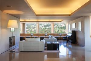 a living room with couches and a fireplace at Hotel Fundador in Guimarães