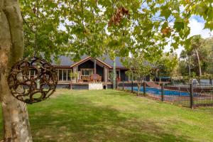 a house with a pool and a tree at Hatuma Paradise in  Waipukurau