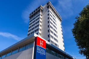 een hotelgebouw met een bord ervoor bij Hotel Fundador in Guimarães