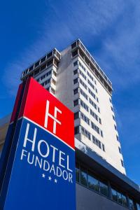 a hotel dupont sign in front of a tall building at Hotel Fundador in Guimarães