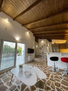 a living room with a table and a kitchen at Casa Fouli - Eretria in Eretria
