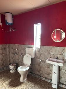 a bathroom with a toilet and a sink at Sylwan-O Sunrise Homestay And Restaurant in Shillong +25 photos