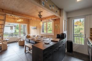 a kitchen with a large island in a room at Les Chaumes - T3 moderne piscine in Cordon