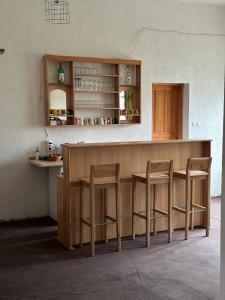 a kitchen with a counter and two stools at Pansion Tomas Kupres in Kupres