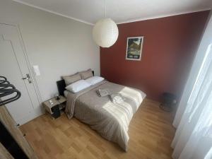 a bedroom with a bed with a white comforter at Comme à la maison B and B in Carcassonne