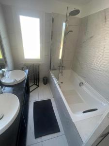 a bathroom with a shower and a tub and a sink at Comme à la maison B and B in Carcassonne +11 photos