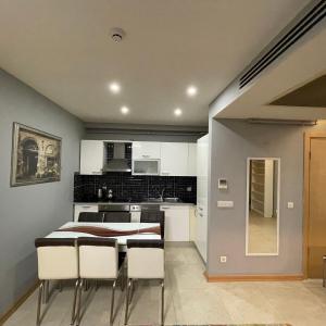 a kitchen and dining room with a table and chairs at Modern Comfort Steps from Taksim in Istanbul +13 photos