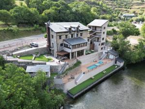 an aerial view of a house on the water at Les Nous Hotel in Rialp
