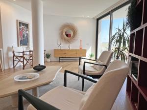 a living room with a table and chairs at Lady Delmar Marina Olhao By Junto ao Mar in Olhão
