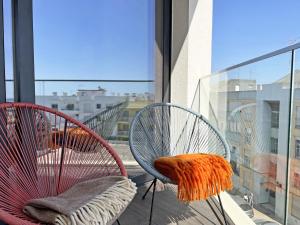 two chairs sitting on a balcony with a view at Lady Delmar Marina Olhao By Junto ao Mar in Olhão