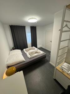 a small bedroom with a bed and a ladder at F5 - 2 Zimmer Wohnung in Offenbach
