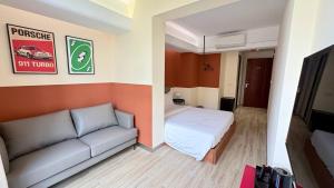 a living room with a couch and a bed at The Guesthouse By SH in Phnom Penh +13 photos