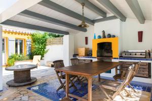 a kitchen with a wooden table and chairs at Les Yeux Bleus Bed & Breakfast in Noirmoutier-en-l'lle