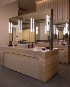 a bathroom with a sink and a large mirror at Blue View Cabins in Reykholt