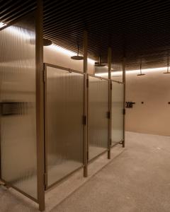 a row of glass doors in a room with lights at Blue View Cabins in Reykholt +85 photos