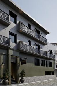 a building with balconies on the side of it at Alkioni Boutique Hotel in Pýli