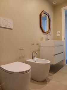 a bathroom with a toilet and a sink and a mirror at Dimora Sant'Allegria in Lecce +75 photos
