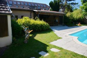 a yard with a pool and a bench next to a house at La Passerelle de la Doller in Reiningue +12 photos