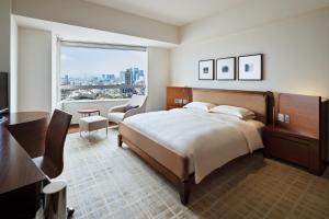 a bedroom with a large bed and a large window at Grand Hyatt Tokyo in Tokyo +261 photos