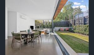 a dining room with a table and chairs at Donatella, Where Heritage Meets Haute Living in Bendigo