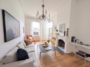a living room with a couch and a fireplace at Donatella, Where Heritage Meets Haute Living in Bendigo