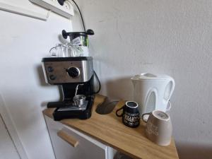 a kitchen counter with a coffee maker on a table at Appartement Fréjus - deux chambres in Fréjus +4 photos