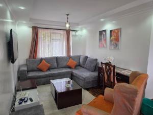 a living room with a couch and a table at Westlands bliss By bliss haven in Nairobi