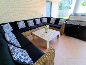 a living room with a couch and a table at Shell Cove,Game Room, 3 Baths, King Bed, 7kW EV Point, Spacious 1-Story Home in Dunmore