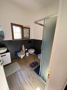 a bathroom with a shower and a toilet and a sink at Vila Blue River in Orikum +87 photos