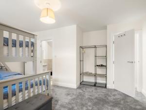 a white bedroom with a bed and a closet at 17 Clifden Court in Clifden