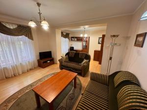 a living room with two couches and a coffee table at Leśny apartament Woziwoda in Legbąd