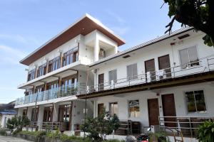 a large white building with balconies on it at Sebay Surf Central San Juan La Union in San Juan