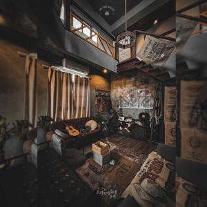 a living room with a couch and a guitar at 旅兜-hostel 蘭嶼 in Lanyu