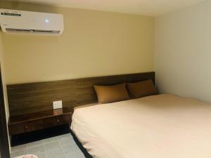 a bedroom with a bed and a air conditioner at Châu Home in Ninh Binh