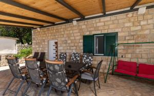 a patio with a table and chairs and a couch at Villa Marevista in Lokva Rogoznica