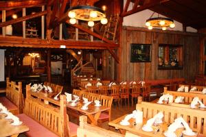 a dining room with wooden tables and chairs at Bayerische Gastwirtschaft Dimpfl-Stadl in Lam