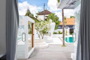 a view of a pool from a window of a house at 3BR Spa Villa, Outdoor Cinema, Sauna & Ice Bath in Ubud