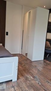 a room with a bed and a white closet at Modernes Apartment im grünen in Kleines Wiesental