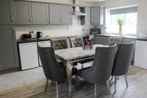 a kitchen with a table and chairs in a kitchen at Joe McGarrity Homestead in Carrickmore