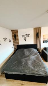 a bedroom with a bed with black birds on the wall at FeWo Markert in Burgtiefe auf Fehmarn  +4 photos