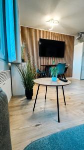 a living room with a table and a tv at FeWo Markert in Burgtiefe auf Fehmarn 