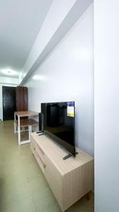a living room with a large flat screen tv at Modern Comfort Studio with City Views in Molo