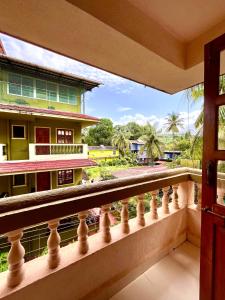 a balcony with a view of a building at 2BHK Apartment 2mins to beach Candolim in Candolim