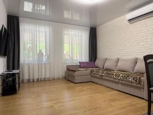 a living room with a couch and a brick wall at Casa Veche 