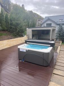 a hot tub on the deck of a house at Luxurious Villa in Sinaia