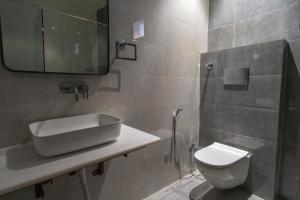a bathroom with a sink and a toilet at White House Royal Living in Jhānsi