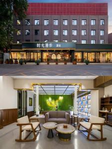 two images of a building with a couch and tables at Nost algia HotelBeijing Panjiayuan Antique Market 时光漫步酒店北京潘家园劲松地铁站店 Free fresh ground coffee,Free laundry service in Beijing