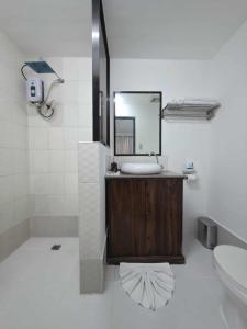 a bathroom with a sink and a mirror at wombats beach resort, bar and restaurant in Olongapo +62 photos