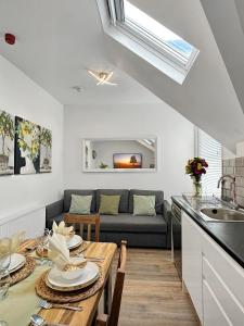 a kitchen and living room with a table and a couch at Granada Apartments at Pleasure Beach in Blackpool