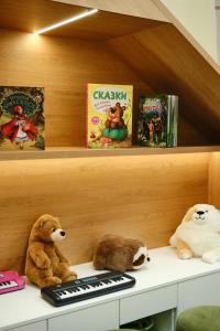 two stuffed animals sitting on a shelf with books at Sheraton Astana Hotel in Astana